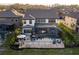 Large fenced backyard with brick patio, pool with screened-in enclosure, and multiple seating areas at 21867 Amelia Rose Way, Land O Lakes, FL 34637