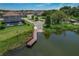 Waterfront view featuring a private dock, scenic pond, and beautiful homes in a tranquil setting at 21867 Amelia Rose Way, Land O Lakes, FL 34637
