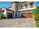 Attractive home with a stone tower, balcony, paver driveway and 3-car garage, and lush landscaping at 21867 Amelia Rose Way, Land O Lakes, FL 34637