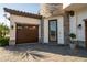 Close up view of a 3-car garage, paver driveway, front door and manicured landscaping at 21867 Amelia Rose Way, Land O Lakes, FL 34637