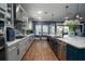 Open gourmet kitchen featuring stainless appliances, light countertops, pendant lighting, and wood flooring at 21867 Amelia Rose Way, Land O Lakes, FL 34637