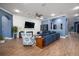Inviting living room with wood-look tile flooring, a fireplace and comfortable seating at 21867 Amelia Rose Way, Land O Lakes, FL 34637
