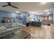 Spacious living room with bar, comfortable seating, and decorative guitars on the wall at 21867 Amelia Rose Way, Land O Lakes, FL 34637