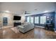The spacious living room features a custom stone wall, a ceiling fan, wood-look flooring, and plenty of natural light at 21867 Amelia Rose Way, Land O Lakes, FL 34637