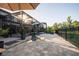 Expansive stone patio with seating overlooking the lake at 21867 Amelia Rose Way, Land O Lakes, FL 34637