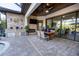 Covered patio features an outdoor dining area with a stone fireplace and a view of the pool at 21867 Amelia Rose Way, Land O Lakes, FL 34637