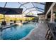 Inviting screened pool area featuring a spa, sun loungers, and outdoor seating with lake views at 21867 Amelia Rose Way, Land O Lakes, FL 34637