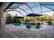 Beautiful screened pool with comfortable lounge chairs and a lake view at 21867 Amelia Rose Way, Land O Lakes, FL 34637