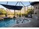 Relaxing screened pool area featuring a spa, water fountains, and ample seating with water views at 21867 Amelia Rose Way, Land O Lakes, FL 34637