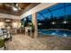Beautiful screened-in pool area with a full outdoor kitchen, bar, and lounge seating at 21867 Amelia Rose Way, Land O Lakes, FL 34637