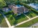 Aerial view of home with lush yard, swimming pool, basketball court and mature palm trees at 307 Oleander Rd, Belleair, FL 33756