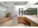 Bright bathroom featuring a soaking tub, walk-in shower, and double vanity at 307 Oleander Rd, Belleair, FL 33756