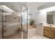 Bathroom with a soaking tub, walk-in shower with glass door, and double vanity at 307 Oleander Rd, Belleair, FL 33756