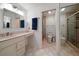 Bathroom featuring a vanity with ample counter space and a shower with glass doors at 307 Oleander Rd, Belleair, FL 33756