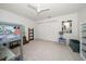 Bright bedroom featuring a ceiling fan, carpet floors, and double closet at 307 Oleander Rd, Belleair, FL 33756