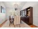 Dining room with a wooden table, chandelier, and dark wood china cabinet at 307 Oleander Rd, Belleair, FL 33756