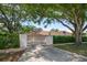 Long driveway leading to a two-car garage, surrounded by mature trees for ample privacy at 307 Oleander Rd, Belleair, FL 33756