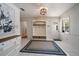 Welcoming foyer features white tile floors, entryway bench, and natural light at 307 Oleander Rd, Belleair, FL 33756