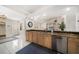Bright eat-in kitchen featuring granite counters, stainless dishwasher, white tiled floors, and an open design at 307 Oleander Rd, Belleair, FL 33756