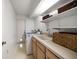 Functional laundry room with washer, dryer, sink, and plenty of storage baskets at 307 Oleander Rd, Belleair, FL 33756