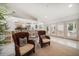Open concept room with chairs, hardwood floors, and open access to the kitchen at 307 Oleander Rd, Belleair, FL 33756