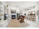 Open concept living room with a fireplace, built-ins, and open access to the kitchen at 307 Oleander Rd, Belleair, FL 33756