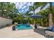 Relaxing backyard pool area features a private pool, patio seating, and lush landscaping at 307 Oleander Rd, Belleair, FL 33756