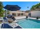 Backyard pool and patio with comfortable seating, perfect for relaxing and entertaining guests at 307 Oleander Rd, Belleair, FL 33756