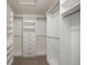Spacious walk-in closet with custom shelving and a clothing rack at 307 Oleander Rd, Belleair, FL 33756