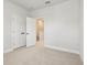 Bedroom with neutral carpet, base trim, and double bi-fold doors to an adjoining room at 3113 4Th N Ter, St Petersburg, FL 33713