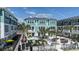 Exterior view of a beautifully landscaped community courtyard with lounge seating, tables, and palm trees on a sunny day at 3113 4Th N Ter, St Petersburg, FL 33713