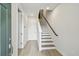 Bright foyer featuring light wood floors, white walls, staircase with black handrail, and interior doors at 3113 4Th N Ter, St Petersburg, FL 33713
