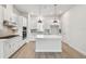 Modern white kitchen boasts stainless steel appliances, an island, and recessed lighting at 3113 4Th N Ter, St Petersburg, FL 33713