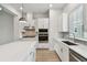 New kitchen with stainless steel appliances, white cabinets and countertops, and gray subway tile backsplash at 3113 4Th N Ter, St Petersburg, FL 33713