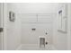 Minimalist laundry room with utility connections, shelving and tile flooring for efficient home management at 3113 4Th N Ter, St Petersburg, FL 33713
