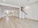 Bright, open-concept living room featuring modern flooring and a view into the kitchen and staircase at 3113 4Th N Ter, St Petersburg, FL 33713