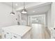Open-concept view from the kitchen island to the living room showcasing bright light and wood floors at 3113 4Th N Ter, St Petersburg, FL 33713