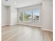 Bright living room features multiple windows for ample natural light and neutral hardwood floors at 3113 4Th N Ter, St Petersburg, FL 33713