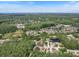 Aerial view of home location within a quiet, well-maintained community, surrounded by lush trees at 3171 Roxmere Dr, Palm Harbor, FL 34685