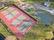 Aerial view of community tennis and basketball courts providing recreational opportunities for residents at 3171 Roxmere Dr, Palm Harbor, FL 34685