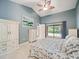 Stylish bedroom featuring a patio door with pool view, a ceiling fan, and white furnishings at 3171 Roxmere Dr, Palm Harbor, FL 34685