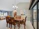 Elegant dining room with a wooden table, upholstered chairs, and a view of the living room at 3171 Roxmere Dr, Palm Harbor, FL 34685