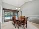 Dining room featuring elegant wood furniture with a view of the screened pool at 3171 Roxmere Dr, Palm Harbor, FL 34685