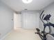 Exercise room has light colored walls, carpet and an elliptical machine at 3171 Roxmere Dr, Palm Harbor, FL 34685