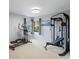 The exercise room features light colored walls, carpet and an elliptical and weight training machine at 3171 Roxmere Dr, Palm Harbor, FL 34685