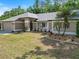 Charming home featuring meticulously maintained landscaping and healthy young palm trees at 3171 Roxmere Dr, Palm Harbor, FL 34685