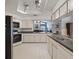 Spacious kitchen with white cabinets, stainless steel appliances, and ample counter space at 3171 Roxmere Dr, Palm Harbor, FL 34685