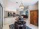 Breakfast nook adjoins a kitchen with stainless appliances, stone countertops and open living area at 3171 Roxmere Dr, Palm Harbor, FL 34685