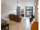Open-concept living room featuring a fireplace, high ceilings, and backyard views at 3171 Roxmere Dr, Palm Harbor, FL 34685