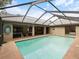 Private screened-in pool with a covered lanai and clear blue skies above, perfect for outdoor enjoyment at 3171 Roxmere Dr, Palm Harbor, FL 34685